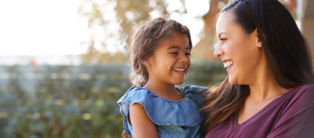 A mother and a child smiling and interacting