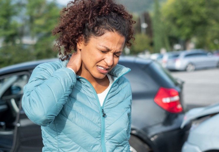 A women experiencing pain in her neck after a personal injury accident